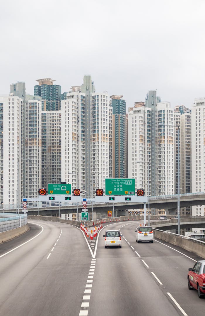 The Art of Drawing Readers In: Your attractive post title goes here A bustling urban scene featuring towering skyscrapers and busy highway traffic under a white sky.